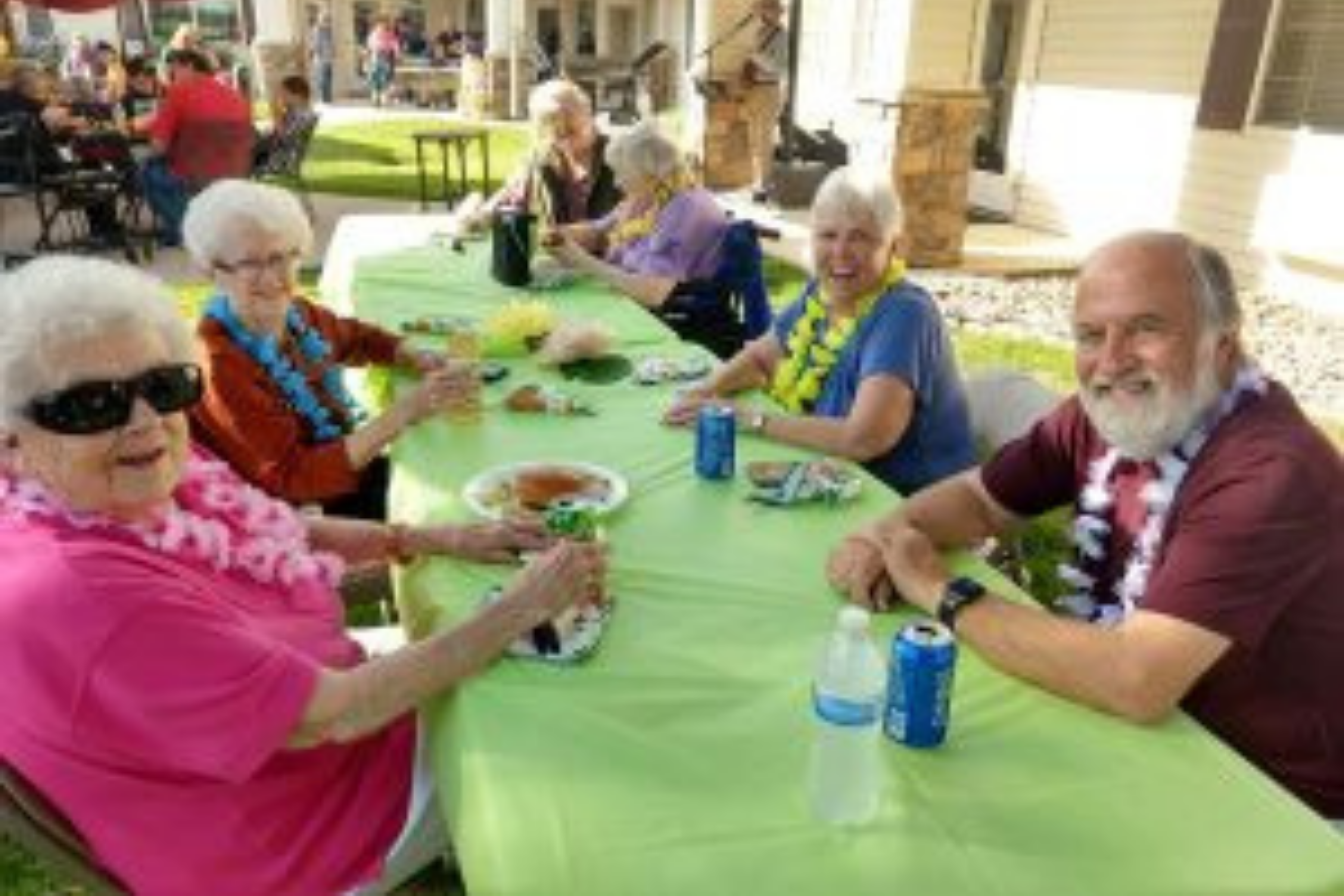 Cappella Pueblo West Senior Living Community in Pueblo West, CO - residents at a gathering large landscape